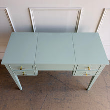 Load image into Gallery viewer, This vintage Craftique vanity has been professionally refinished in a custom light teal lacquer, giving the classic form a fresh, tailored look. Clean lines and tapered legs reflect the refined simplicity Craftique furniture is known for, while new lucite and brass hardware adds a subtle touch of modern glamour. Good Bones Furniture
