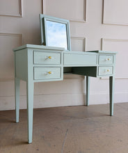 Load image into Gallery viewer, This vintage Craftique vanity has been professionally refinished in a custom light teal lacquer, giving the classic form a fresh, tailored look. Clean lines and tapered legs reflect the refined simplicity Craftique furniture is known for, while new lucite and brass hardware adds a subtle touch of modern glamour. Good Bones Furniture
