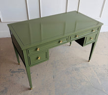 Load image into Gallery viewer, Vintage desk by Drexel Furniture combines practical workspace with timeless architectural detailing. Professionally lacquered in Farrow &amp; Ball Bancha, its earthy olive-green finish highlights the framed drawer fronts, inset desktop border, and slender tapered legs. Four drawers, original polished brass hardware and brass-capped feet. Good Bones Furniture
