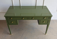 Load image into Gallery viewer, Vintage desk by Drexel Furniture combines practical workspace with timeless architectural detailing. Professionally lacquered in Farrow &amp; Ball Bancha, its earthy olive-green finish highlights the framed drawer fronts, inset desktop border, and slender tapered legs. Four drawers, original polished brass hardware and brass-capped feet. Good Bones Furniture
