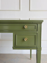 Load image into Gallery viewer, Vintage desk by Drexel Furniture combines practical workspace with timeless architectural detailing. Professionally lacquered in Farrow &amp; Ball Bancha, its earthy olive-green finish highlights the framed drawer fronts, inset desktop border, and slender tapered legs. Four drawers, original polished brass hardware and brass-capped feet. Good Bones Furniture
