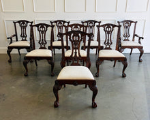 Load image into Gallery viewer, This vintage Drexel Heritage Nine Elms dining set showcases richly figured crotch mahogany veneer framed by contrasting banding. The expansive table rests on two ornately carved pedestal bases and includes three 22-inch leaves, extending it to an impressive 140 inches for large gatherings. Eight coordinating chairs—two armchairs and six side chairs. Good Bones Furniture
