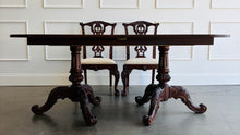 Load image into Gallery viewer, This vintage Drexel Heritage Nine Elms dining set showcases richly figured crotch mahogany veneer framed by contrasting banding. The expansive table rests on two ornately carved pedestal bases and includes three 22-inch leaves, extending it to an impressive 140 inches for large gatherings. Eight coordinating chairs—two armchairs and six side chairs. Good Bones Furniture
