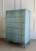 Load image into Gallery viewer, A classic French Provincial silhouette refreshed with a clean, modern lacquer finish. This vintage five-drawer chest features softly shaped drawer fronts, a gently serpentine apron, and cabriole-style feet that give it an elegant, airy profile. Finished in a custom Parma Gray mix, the color reads as a sophisticated blue-gray that shifts beautifully with natural light, and it’s completed with polished brass ginkgo leaf hardware for a warm, sculptural contrast. Good Bones Furniture
