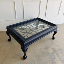 Load image into Gallery viewer, This vintage coffee table pairs traditional craftsmanship with a fresh, tailored finish. Lacquered in Sherwin Williams Naval, the deep blue tone gives the piece a bold, sophisticated presence while highlighting its elegant silhouette. Ball and claw feet and carved detailing lend classic character, while the inset glass top keeps the overall look light and polished. Good Bones Furniture

