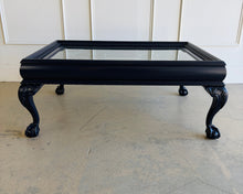 Load image into Gallery viewer, This vintage coffee table pairs traditional craftsmanship with a fresh, tailored finish. Lacquered in Sherwin Williams Naval, the deep blue tone gives the piece a bold, sophisticated presence while highlighting its elegant silhouette. Ball and claw feet and carved detailing lend classic character, while the inset glass top keeps the overall look light and polished. Good Bones Furniture
