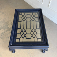 Load image into Gallery viewer, This vintage coffee table pairs traditional craftsmanship with a fresh, tailored finish. Lacquered in Sherwin Williams Naval, the deep blue tone gives the piece a bold, sophisticated presence while highlighting its elegant silhouette. Ball and claw feet and carved detailing lend classic character, while the inset glass top keeps the overall look light and polished. Good Bones Furniture
