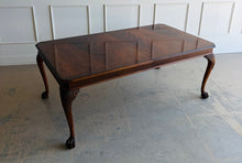 Load image into Gallery viewer, A timeless Henredon dining table crafted with exceptional attention to detail and beautiful figured mahogany veneers. The richly grained top showcases dramatic cathedral patterns framed by a contrasting mahogany border, while the carved cabriole legs with ball-and-claw feet reflect classic Chippendale-inspired design. Good Bones Furniture
