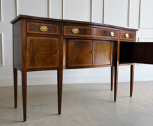 Load image into Gallery viewer, Vintage Hickory Chair sideboard showcasing classic Federal-inspired styling with beautifully banded mahogany veneers, graceful serpentine lines, and tapered legs. The thoughtfully designed layout includes three drawers above three cabinet compartments, offering versatile storage for dining essentials, serving pieces, or barware. Rich mahogany grain, satin brass hardware, and refined inlay details. Good Bones Furniture
