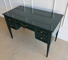 Load image into Gallery viewer, This beautifully refinished vintage desk offers timeless design with a fresh, designer-inspired finish. Professionally lacquered in Sherwin-Williams Rookwood Sash Green in a high-gloss sheen, it makes a bold yet sophisticated statement while preserving its classic mid-century silhouette. Five spacious drawers provide practical storage for office essentials, and the new antiqued brass hardware adds warmth and elegance against the rich green lacquer. Good Bones Furniture
