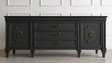 Load image into Gallery viewer, This vintage Mediterranean/ Spanish Revival credenza dresser has the scale, craftsmanship, and presence that make 1970s American case goods so collectible. The design features a carved scrolling frieze, burl veneer door panels, architectural legs, and original brass ring hardware with geometric backplates. Good Bones Furniture
