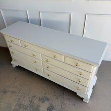 Load image into Gallery viewer, This vintage dresser by National Mt. Airy combines traditional craftsmanship with a fresh, updated finish. The silhouette is classic and balanced, with softly shaped feet, subtle crown molding, and clean paneled drawer fronts that give the piece a tailored, timeless presence. Professionally lacquered in a custom greige, the finish brings a versatile neutral tone that feels warm, refined, and easy to place in a range of interiors. Good Bones Furniture
