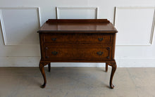 Load image into Gallery viewer, This vintage Queen Anne-style two drawer chest features richly figured wood grain, graceful cabriole legs, carved corner details, and classic brass hardware. The compact scale makes it especially versatile as a bedside chest, entryway piece, small dresser, or accent cabinet. Good Bones Furniture
