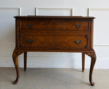 Load image into Gallery viewer, This vintage Queen Anne-style two drawer chest features richly figured wood grain, graceful cabriole legs, carved corner details, and classic brass hardware. The compact scale makes it especially versatile as a bedside chest, entryway piece, small dresser, or accent cabinet. Good Bones Furniture
