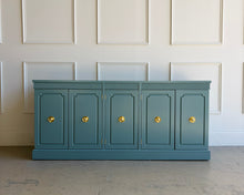 Load image into Gallery viewer, This vintage Stanley credenza brings mid-century simplicity and strong proportions together in a fresh, elevated finish. Lacquered in Benjamin Moore Aegean Teal, it reads rich and modern while still letting the original design do the talking—clean lines, a flat rectangular top with crisp edges, and a solid plinth base that grounds the piece visually. 
