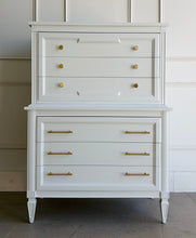 Load image into Gallery viewer, This vintage Thomasville chest on chest provides generous storage within a tall, space-conscious silhouette. Professionally lacquered in Benjamin Moore White Dove, its softly warm off-white finish has subtle creamy undertones that feel bright without appearing stark. Six spacious drawers are arranged across two architecturally framed sections, creating the appearance of stacked chests. New brass knobs and linear pulls. Good Bones Furniture
