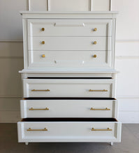 Load image into Gallery viewer, This vintage Thomasville chest on chest provides generous storage within a tall, space-conscious silhouette. Professionally lacquered in Benjamin Moore White Dove, its softly warm off-white finish has subtle creamy undertones that feel bright without appearing stark. Six spacious drawers are arranged across two architecturally framed sections, creating the appearance of stacked chests. New brass knobs and linear pulls. Good Bones Furniture

