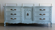 Load image into Gallery viewer, This vintage Thomasville dresser has been professionally lacquered in Farrow &amp; Ball Parma Gray, a soft blue-gray finish that gives its French Provincial styling a fresh, updated look. The piece features a serpentine front, cabriole legs, ornate carved detailing, and original patinaed hardware that adds warmth and character. Good Bones Furniture
