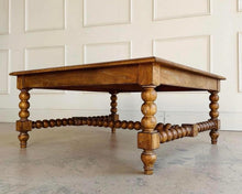 Load image into Gallery viewer, The Wellmington Coffee Table is a beautiful statement piece that brings both character and functionality to any living space. Crafted from solid Mango wood, it features stunning large bobbin legs and cross braces that highlight its traditional craftsmanship. The substantial square design ensures ample surface area, making it perfect for both decorative displays and everyday use. Good Bones Furniture
