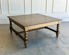 Load image into Gallery viewer, The Wellmington Coffee Table is a beautiful statement piece that brings both character and functionality to any living space. Crafted from solid Mango wood, it features stunning large bobbin legs and cross braces that highlight its traditional craftsmanship. The substantial square design ensures ample surface area, making it perfect for both decorative displays and everyday use. Good Bones Furniture
