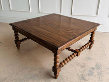 Load image into Gallery viewer, The Wellmington Coffee Table is a beautiful statement piece that brings both character and functionality to any living space. Crafted from solid Mango wood, it features stunning large bobbin legs and cross braces that highlight its traditional craftsmanship. The substantial square design ensures ample surface area, making it perfect for both decorative displays and everyday use. Good Bones Furniture
