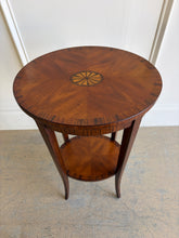 Load image into Gallery viewer, This elegant Wildwood accent table draws heavily from classic Federal and Regency design, featuring an oval silhouette, tapered saber legs, and richly patterned mahogany veneers inspired by fine English antiques. The proportions feel graceful and architectural, while the warm finish and decorative inlay work give the piece exceptional depth and character. Good Bones Furniture
