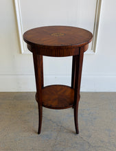 Load image into Gallery viewer, This elegant Wildwood accent table draws heavily from classic Federal and Regency design, featuring an oval silhouette, tapered saber legs, and richly patterned mahogany veneers inspired by fine English antiques. The proportions feel graceful and architectural, while the warm finish and decorative inlay work give the piece exceptional depth and character. Good Bones Furniture
