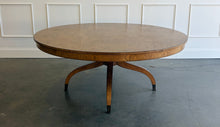 Load image into Gallery viewer, The Williamsburg Dining Table combines dramatic wood grain with a graceful, sculptural base. Crafted from mahogany solids, its expansive round top is available in your choice of richly figured burled ash or cerejeira veneer. Carefully arranged veneer panels create movement across the tabletop, while the substantial veneered apron adds visual depth. Four sweeping legs extend from the central pedestal and terminate in brass-capped feet. Good Bones Furniture
