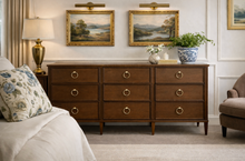 Load image into Gallery viewer, Avalaire 9 Drawer Dresser in Sorrel Mahogany styled in a traditional bedroom with layered lighting and artwork by Good Bones Furniture
