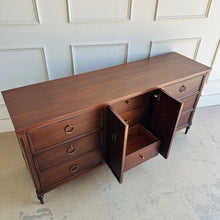Load image into Gallery viewer, Top angled view of the Boylan 9 drawer credenza dresser showing smooth satin lacquer finish and center cabinet storage.
