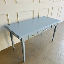 Load image into Gallery viewer, Vintage Ethan Allen writing desk professionally lacquered in Sherwin-Williams Dockside Blue, featuring a classic silhouette with turned legs, lucite and brass hardware, and a spacious desktop for home office use.
