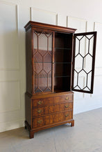 Load image into Gallery viewer, A true heirloom piece from Hickory Chair, this cabinet showcases everything that defines high-end traditional furniture—exceptional materials, precise craftsmanship, and timeless design. The case is wrapped in beautifully bookmatched crotch mahogany veneer, creating dramatic movement across the drawer fronts, while the glazed doors feature geometric muntins that give the piece a tailored, architectural feel. Good Bones Furniture
