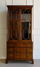 Load image into Gallery viewer, A true heirloom piece from Hickory Chair, this cabinet showcases everything that defines high-end traditional furniture—exceptional materials, precise craftsmanship, and timeless design. The case is wrapped in beautifully bookmatched crotch mahogany veneer, creating dramatic movement across the drawer fronts, while the glazed doors feature geometric muntins that give the piece a tailored, architectural feel. Good Bones Furniture

