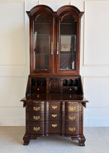 Load image into Gallery viewer, Vintage Hooker secretary desk with drop-front open, revealing traditional interior cubbies and small drawers beneath illuminated glass display cabinet in mahogany finish.
