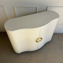 Load image into Gallery viewer, Top view of the Highland House Jules Cabinet emphasizing its sculptural curved silhouette and smooth creamy white lacquer finish.

