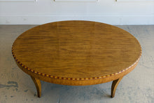 Load image into Gallery viewer, Top view of Lillian August coffee table showcasing warm wood grain and decorative inlay banding along the oval edge.
