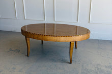Load image into Gallery viewer, Transitional Lillian August coffee table featuring an elegant oval silhouette, rich wood grain, and tapered legs, ideal for living room styling.
