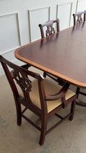 Load and play video in Gallery viewer, Classic proportions and refined craftsmanship give this vintage banded mahogany dining table its timeless appeal. The rich mahogany top is framed by a contrasting banded edge that adds subtle visual definition, while the double pedestal base brings balance, elegance, and stability. Carved pedestal details and brass-capped feet. Good Bones Furniture
