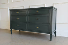 Load image into Gallery viewer, Six-drawer vintage dresser professionally lacquered in Farrow &amp; Ball Studio Green, featuring fluted detailing, modern acrylic and brass hardware, and classic tapered legs.
