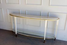 Load image into Gallery viewer, Angled left hero view of the Judith Leiber console by Theodore Alexander, emphasizing its sculptural demi-lune form, white lacquer finish, and refined brass accents
