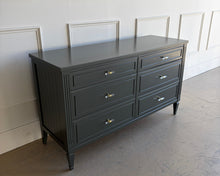 Load image into Gallery viewer, Angled view of a Studio Green lacquered vintage dresser with fluted side panels, six spacious drawers, and tapered legs, refinished in Farrow &amp; Ball by Good Bones Furniture.
