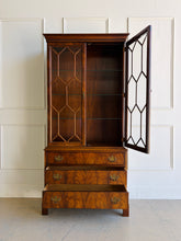 Load image into Gallery viewer, A true heirloom piece from Hickory Chair, this cabinet showcases everything that defines high-end traditional furniture—exceptional materials, precise craftsmanship, and timeless design. The case is wrapped in beautifully bookmatched crotch mahogany veneer, creating dramatic movement across the drawer fronts, while the glazed doors feature geometric muntins that give the piece a tailored, architectural feel. Good Bones Furniture
