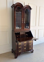 Load image into Gallery viewer, Angled view of vintage Hooker Secretary with open drop-front writing surface, brass hardware, bracket feet, and glass-paneled upper cabinet.
