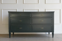 Load image into Gallery viewer, Front view of a vintage six-drawer dresser professionally lacquered in Farrow &amp; Ball Studio Green by Good Bones Furniture, featuring fluted side detailing, tapered legs, and clear acrylic and brass hardware.

